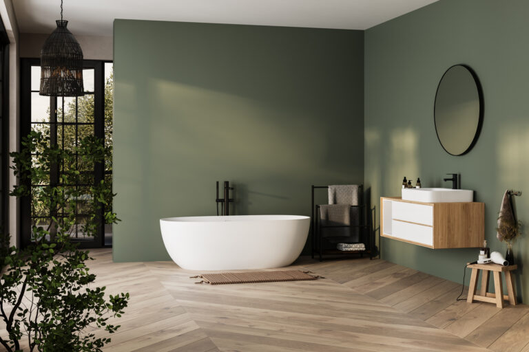 A Scandinavian-style bathroom with an olive green wall, light wood flooring, and a white bathtub. A wooden vanity stands on the right side of the room. The interior features black accents, such as a mirror hanging above it. In front is a large window overlooking the natural scenery outside. There are also some plants in vases scattered around for decoration. This design creates a cozy atmosphere that reflects minimalism and natural elements. --ar 110:73